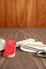 Manicure tools, scissors, nail file, cotton swab on the wooden table