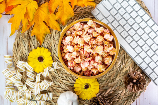 Top Down Flatlay For Autumn Snacking, Office And Work Concepts. Bowl Of Flavored Popcorn, With. Maple Leaves, Keyboard, Pine Cones And Sunflowers