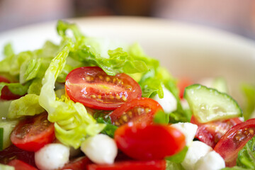 Summer salad. Fresh salad with mozzarella. Lettuce with cherry tomatoes, cucumbers and mozzarella. Bebe mozzarella. Diet salad. Vegetarian salad