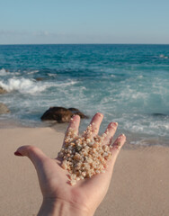 Hand showing Sand on the beach