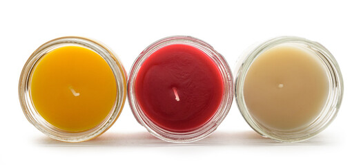 a set of multicolored scented candles in transparent jars on a white background