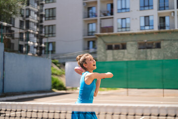Sportive young girl with racquet playing padel in the open court outdoors