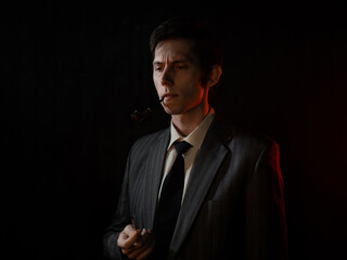 A serious young man smoking a pipe, a man in a gray suit with a tie, deep shadows in a retro noir style