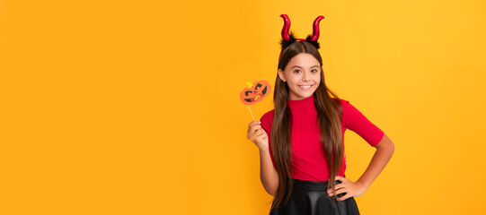 happy halloween. devil kid with pumpkin party accessory. trick or treat. teen girl. Halloween kid girl portrait, horizontal poster. Banner header with copy space.