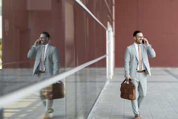 Portrait of a young businessman holding phone. Business stock photo. Reflection in glass
Talking on phone