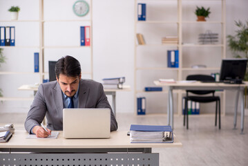 Young male employee working in the office