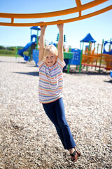 Fototapeta na wymiar Happy Little Girl Playing on the School Playground