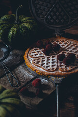 Food photography in a low key pumpkin waffles in a retro waffle iron