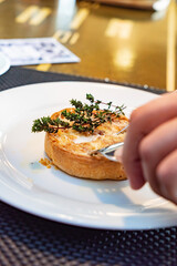 woman eating vegetable pie in cafe