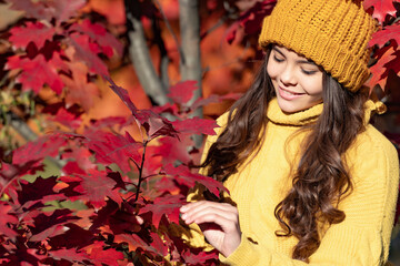 Child girl in autumn fall park outdoor, kids fun face. smiling teen girl in hat at autumn leaves on natural background