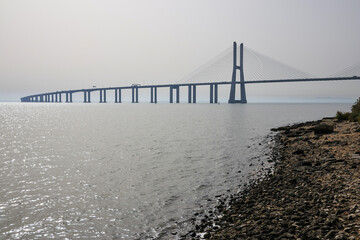 Beautiful landscape at sunrise on the Tagus river next to Vasco de Gama bridge in Lisbon, Portugal