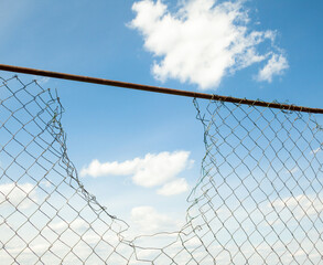 Broken metal mesh fence