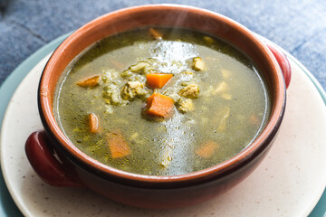 Peruvian food soup with cilantro, carrots and chicken called aguadito. 