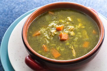Peruvian food soup with cilantro, carrots and chicken called aguadito. 