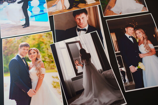 printed wedding photos on a black background.