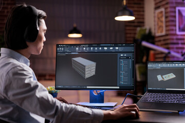 Naklejka premium Male engineer working on industrial manufacture of technical engine product with infographics interface. Developing machinery component with engineering manufactory for science development.