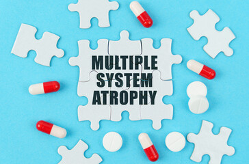 On a blue background, pills, capsules and puzzles with the inscription - Multiple system atrophy