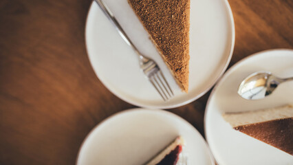 Fresh cheesecakes on round wooden table.