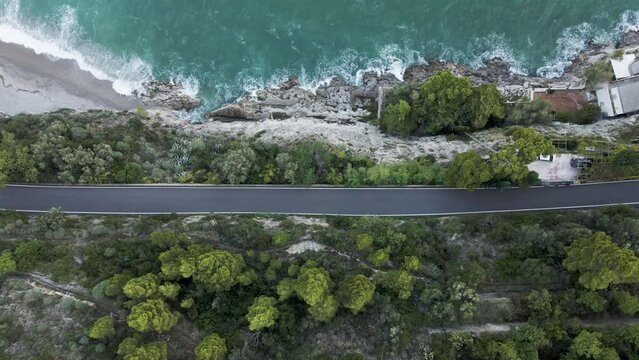 Aerial view of a vehicle driving a road on the cliffs in Cetara, Amalfi Coast, Salerno, Campania, Italy.