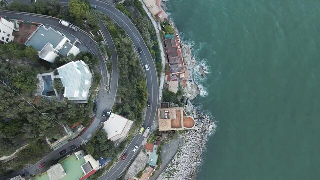 Aerial view of a vehicle driving a road on the cliffs in Cetara, Amalfi Coast, Salerno, Campania, Italy.
