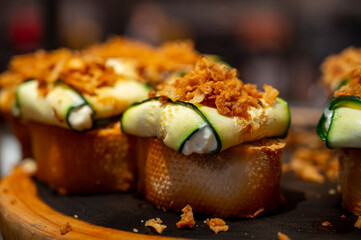 Typical snack of Basque Country and Navarre, pinchos or pinxtos served in bar, small slices of bread upon which ingredient or mixture of ingredients is placed, San Sebastian, Spain