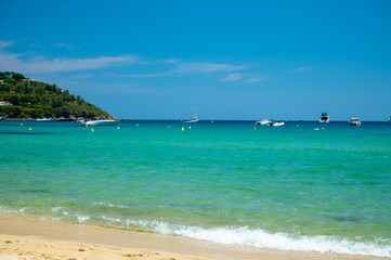 Crystal clear blue water of legendary Pampelonne beach near Saint-Tropez, summer vacation on white sandy beaches of French Riviera, France