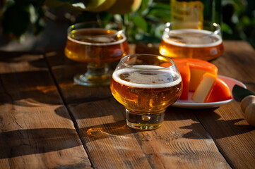 Food and drink pairing, apple cider produced on organic farm from bio apples in Normandy, France and cheddar cheese from England