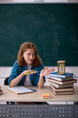 Young female student in time management concept