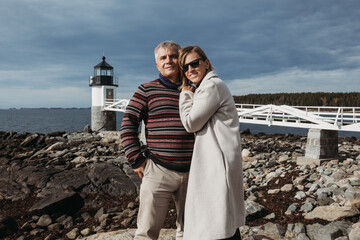 middle age couple standing and hugging and smiling - Powered by Adobe