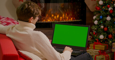 Man have video call with family on Christmas. Laptop Green Screen Chroma Key. Christams Background. Communication technology.