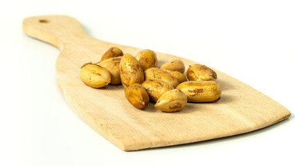 Group of fresh raw hazelnut kernels on the wooden surface isolated on white background. Close-up of fresh hazelnut