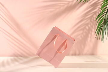 Empty paper bag on a light background with shadows, the concept of a sale and delivery of purchases. Banner for advertising a store, supermarket, restaurant, minimal creative composition, 