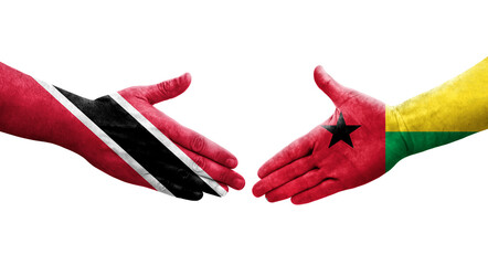 Obraz premium Handshake between Guinea Bissau and Trinidad Tobago flags painted on hands, isolated transparent image.
