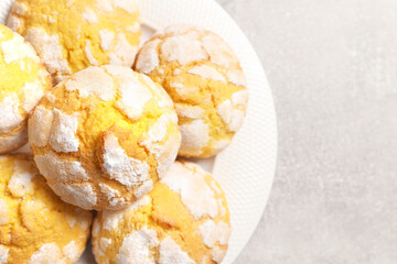 Plate with tasty lemon cookies on grey table, top view