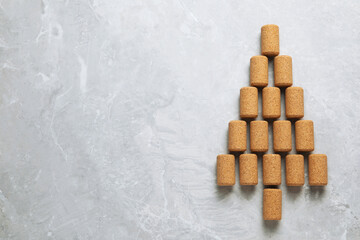 Christmas tree made of wine corks on light grey table, top view. Space for text