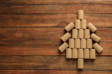 Christmas tree made of wine corks on wooden table, top view. Space for text