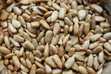 Pile of peeled sunflower seeds as background, closeup