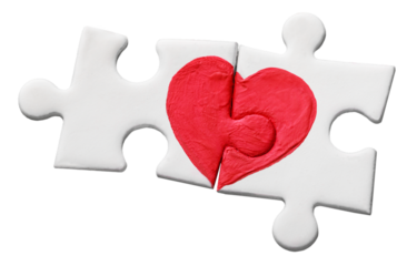 Puzzle pieces with painted red heart isolated on white background