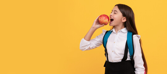 Knowledge is tasty. School girl child eat apple. Knowledge day. Portrait of schoolgirl student, studio banner header. School child face, copyspace.