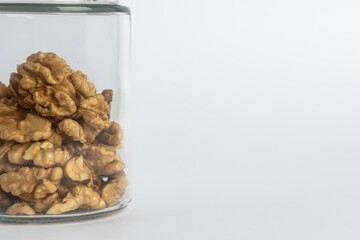 The walnut kernels in jar isolated on white background. close-up walnut ,healthy food concept