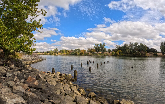 Old abandoned dock on sacramento river on a partially cloudy day