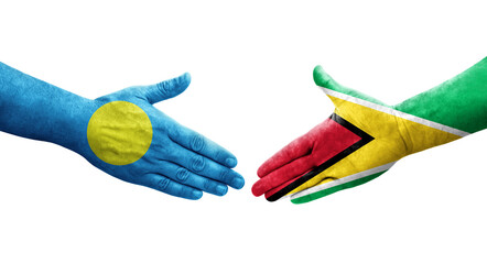 Handshake between Guyana and Palau flags painted on hands, isolated transparent image.
