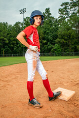 Youth Child Boy Baseball Player Standing on A Muddy Baseball Field