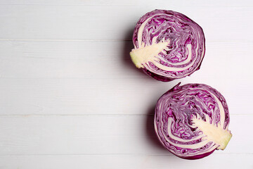 Halves of ripe red cabbage on white wooden table, flat lay. Space for text - Powered by Adobe