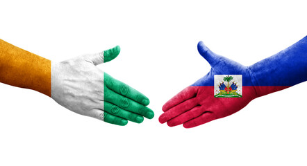 Handshake between Haiti and Ivory Coast flags painted on hands, isolated transparent image.