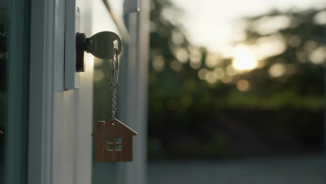 The house key is inserted in front of the door and opens to welcome the new owner. Home selling ideas, home mortgage