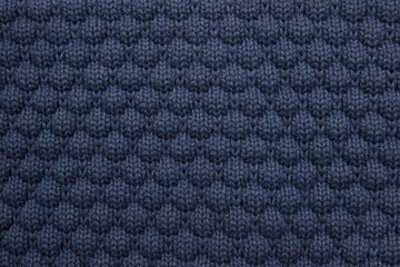 Blue background of knitted fabric, sweater close-up, concept of warm autumn and winter clothing, care washing and dry cleaning, with an empty space for the fabric, copy space, decoration, упаковка