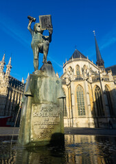 View of Fonske statue and fountain on central square of Leuven city on background of impressive...