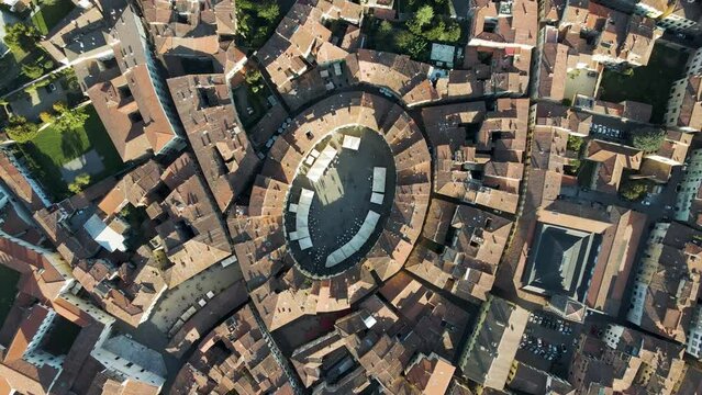 Aerial view of Piazza dell'Anfiteatro, a medieval square with caf&egrave; and market in Lucca old town, Tuscany, Italy.