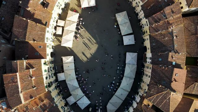 Aerial view of Piazza dell'Anfiteatro, a medieval square with caf&egrave; and market in Lucca old town, Tuscany, Italy.